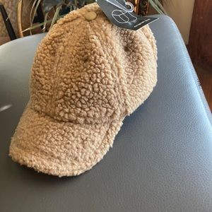 Keep cozy with this cute fuzzy hat, featured in a ball cap style. Adjustable.